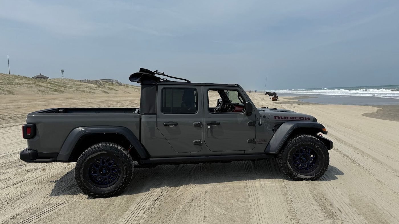 Real photo: a gray Jeep Gladiator Rubicon parked on the Carova 4x4 beach.